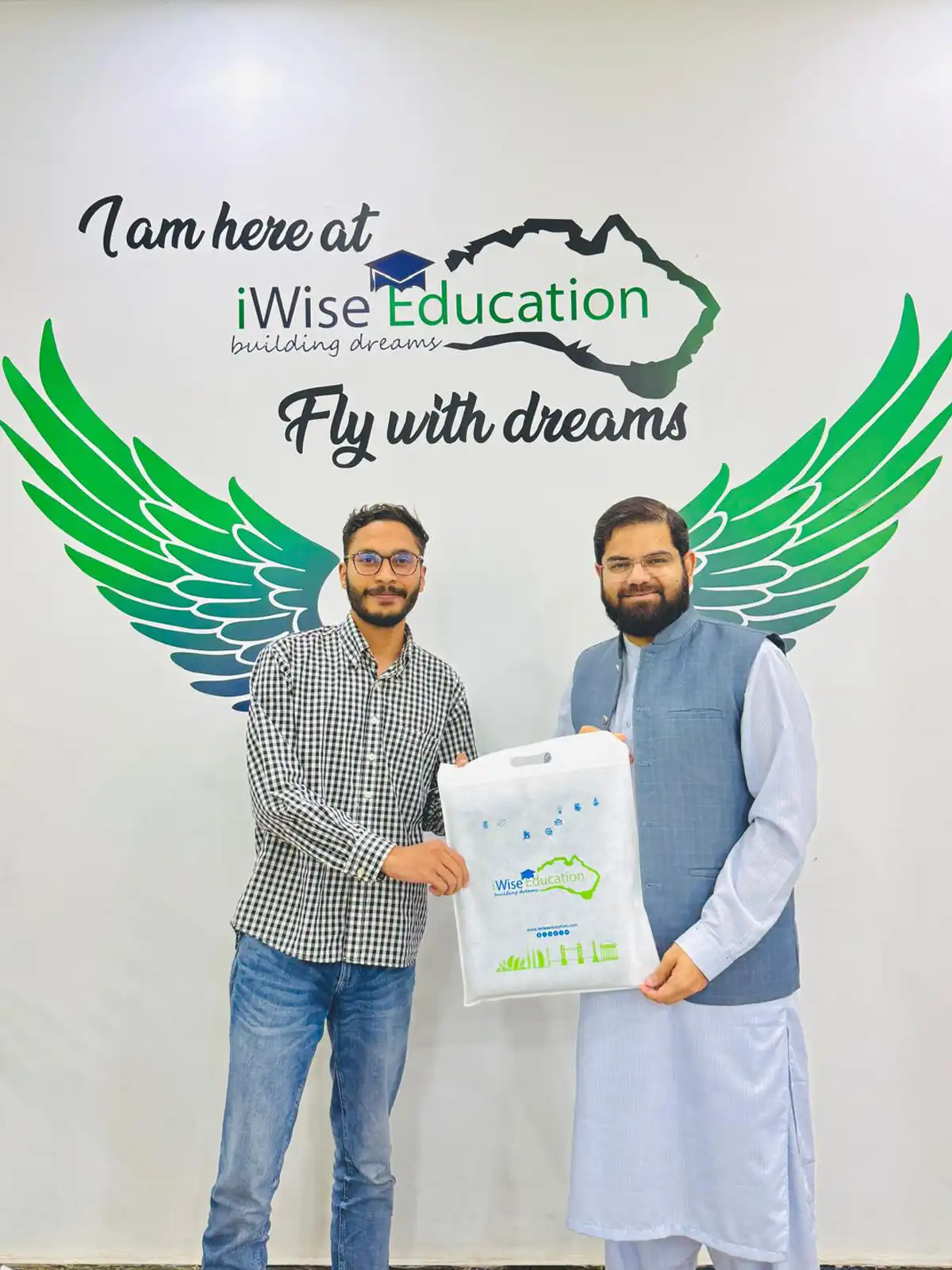 Managing Partner iWise Education Dr Hammad Naeem giving a gift to a successful student